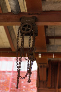 Low angle view of chain hanging on ceiling