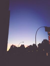 Low angle view of silhouette trees against sky at sunset