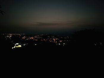 Illuminated cityscape against sky at night