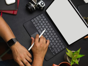 Low section of person using laptop on table