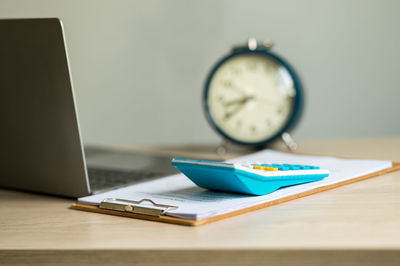 Close-up of clock on table