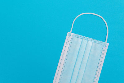 Low angle view of paper against blue sky