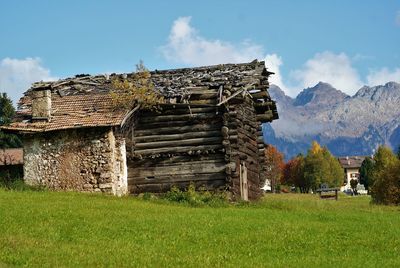 Abandoned built structure on field against sky