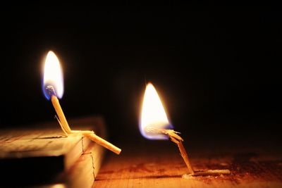 Close-up of burning candle in darkroom