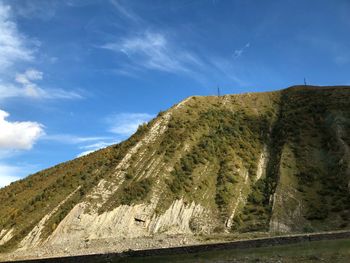 Scenic view of mountains against blue sky