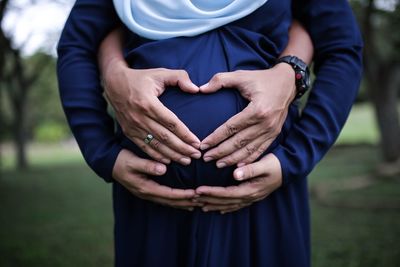 Midsection of woman holding hands