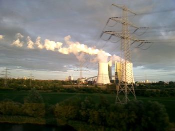 Scenic view of field against cloudy sky