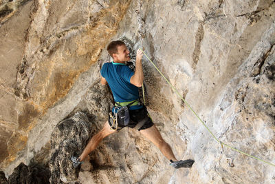 Full length of man with rope on rock