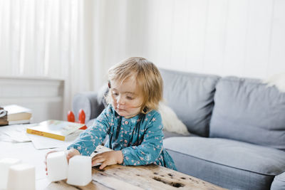 Cute girl playing with toys at home