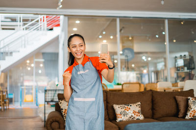 Portrait of young woman standing in store