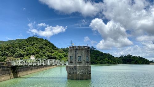 Panoramic view of river by trees against sky