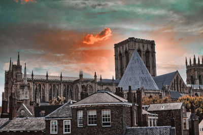Buildings in city against sky during sunset