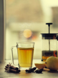 Cup of lemon hot tea honey and cinnamon stick with dried star anise 