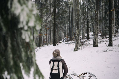 Full length of child in snow covered forest