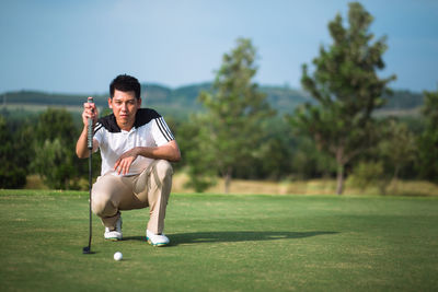 Full length of man standing on golf course