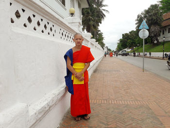 Portrait of smiling man standing against wall