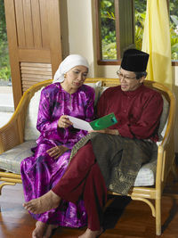 Two people sitting in a traditional clothing