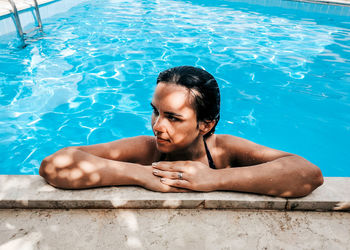 Young woman in bikini in swimming pool. summer, lifestyle.