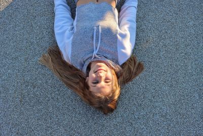 High angle portrait of woman lying on floor