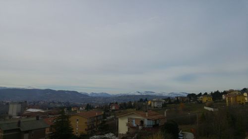 High angle view of houses in town against sky