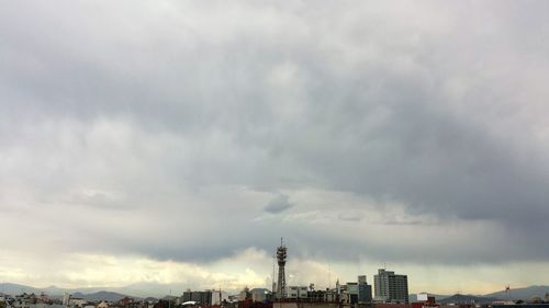 Low angle view of buildings against cloudy sky