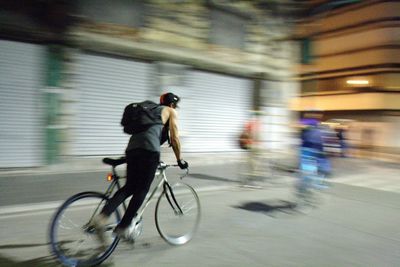 Blurred motion of people walking on road at night