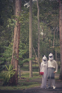 Bride an groom in costume at park