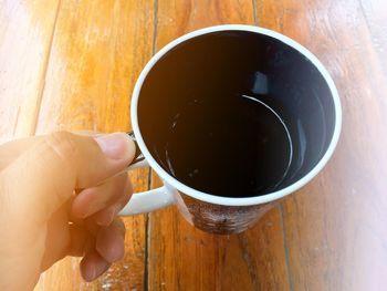 Midsection of person holding coffee cup