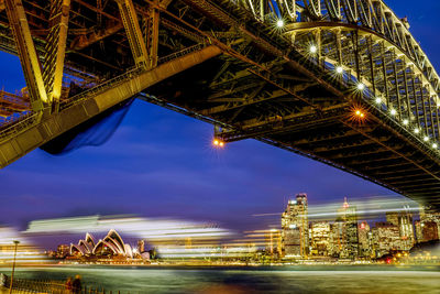 Illuminated bridge against sky at night