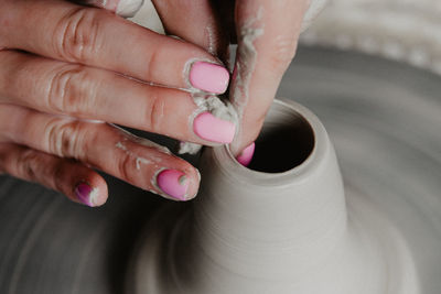 Midsection of woman at pottery workshop