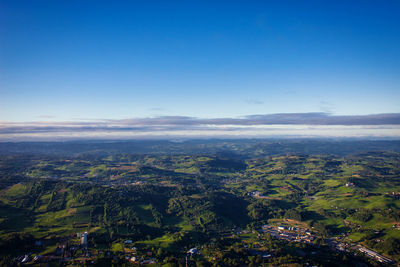Aerial view of landscape against clear blue sky