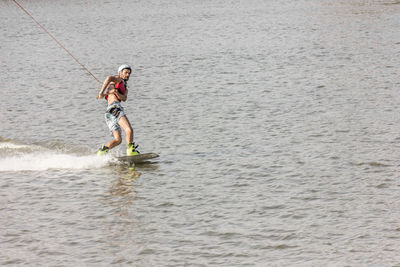 Full length of woman surfing in sea