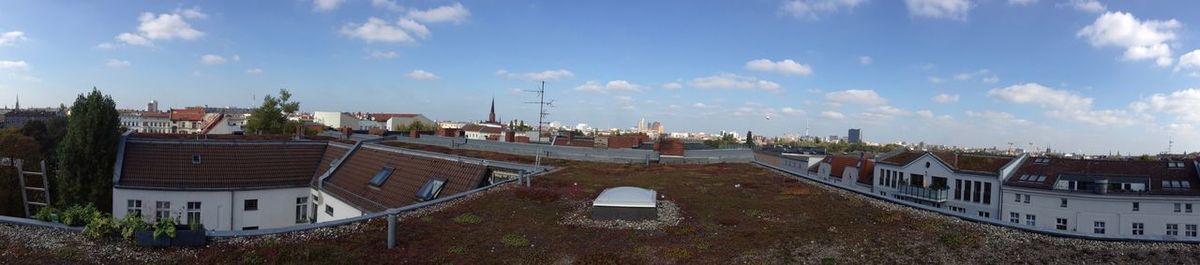 High angle view of houses in town against sky