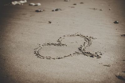High angle view of text on sand at beach