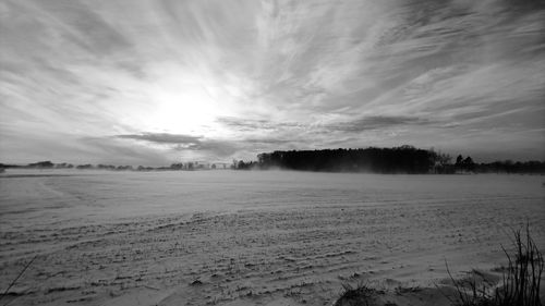 Scenic view of landscape against sky during winter