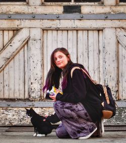 Portrait of young woman sitting outdoors