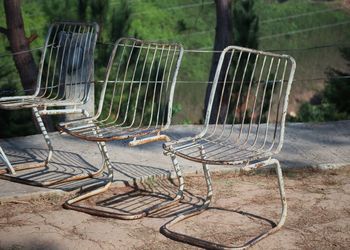 Empty chairs and tables in forest