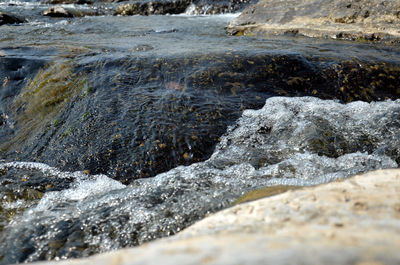 Close-up of water flowing through rocks