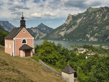 Scenic view of buildings and mountains against sky