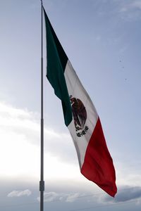 Low angle view of mexican flag against sky