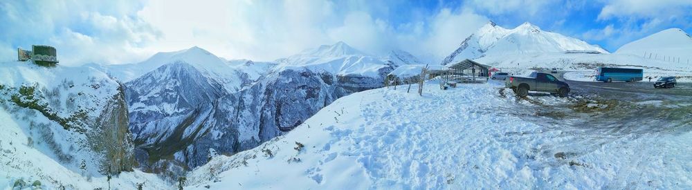 Panoramic view of snowcapped mountains against sky