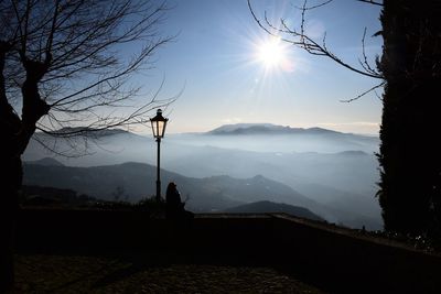 Scenic view of silhouette mountains against sky at sunset