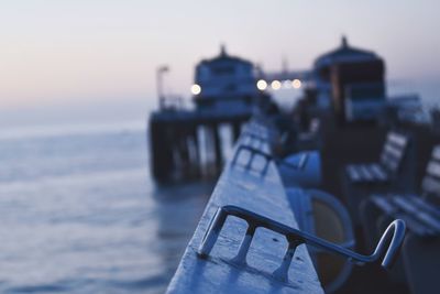 Close-up of metallic ship against sea at sunset