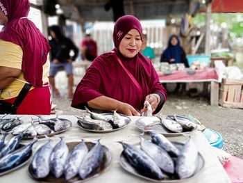 Portrait of woman standing in market