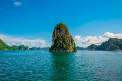 Scenic view of bay against blue sky