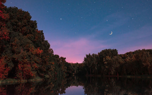 Scenic view of lake against sky at night