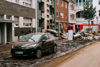 Cars on street by buildings in city