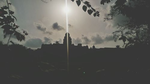 Low angle view of silhouette trees against sky