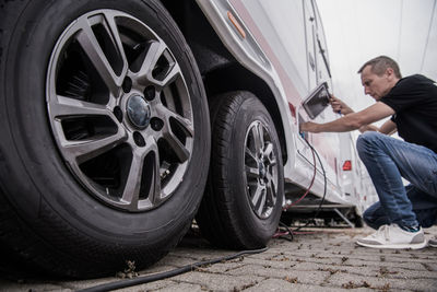 Man charging car outdoors