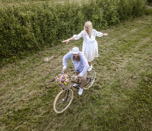 Woman riding bicycle on field